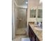 Bathroom showcasing a glass-enclosed shower, granite countertop and modern fixtures at 16904 Vardon Ter # 201, Bradenton, FL 34211