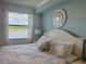 Bright bedroom featuring a large window with a beautiful view and white furniture at 16904 Vardon Ter # 201, Bradenton, FL 34211