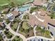 Aerial view showcases the clubhouse, pool, and lush landscaping, highlighting the community's luxurious amenities at 16904 Vardon Ter # 201, Bradenton, FL 34211