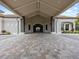 Covered entrance with stone columns and a brick paved drive leading into the community clubhouse at 16904 Vardon Ter # 201, Bradenton, FL 34211
