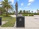 Community features a well-maintained garbage receptacle with palm trees and golf carts at 16904 Vardon Ter # 201, Bradenton, FL 34211