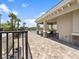 Inviting community pool area with covered seating, pavers, and lush tropical landscaping at 16904 Vardon Ter # 201, Bradenton, FL 34211