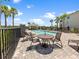 Community pool area with tables and chairs, providing a relaxing outdoor amenity at 16904 Vardon Ter # 201, Bradenton, FL 34211