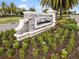 Stone community sign surrounded by beautiful landscaping with vibrant flowers and greenery at 16904 Vardon Ter # 201, Bradenton, FL 34211