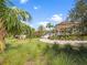 Lush green community space with a covered sitting area and mature landscaping at 16904 Vardon Ter # 201, Bradenton, FL 34211