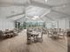 Spacious dining room featuring elegant tables, chairs, and expansive windows showcasing the beautiful outdoors at 16904 Vardon Ter # 201, Bradenton, FL 34211