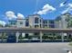 Exterior of condominium with portico and Spanish-tile roof, with cars parked in covered spaces at 16904 Vardon Ter # 201, Bradenton, FL 34211