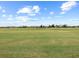 Manicured golf course featuring lush green lawns, a serene landscape, and clear skies at 16904 Vardon Ter # 201, Bradenton, FL 34211