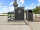 Golf course amenity featuring a waste disposal unit and shelf for golfers' convenience at 16904 Vardon Ter # 201, Bradenton, FL 34211