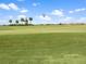 Golf course green on a sunny day, showcasing the well-manicured lawn and lush landscaping at 16904 Vardon Ter # 201, Bradenton, FL 34211
