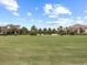 Scenic view of the manicured golf course, clubhouse and the community's verdant landscaping at 16904 Vardon Ter # 201, Bradenton, FL 34211