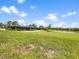 Expansive green space including a tennis court, pond, and residential area at 16904 Vardon Ter # 201, Bradenton, FL 34211