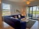 Spacious living room with water view from balcony, comfortable seating, and stylish décor at 16904 Vardon Ter # 201, Bradenton, FL 34211
