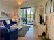 Living room area with water view from balcony, comfortable seating, and decorative table at 16904 Vardon Ter # 201, Bradenton, FL 34211