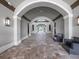 Grand arched entryway featuring stone floors and elegant lighting, inviting guests into a luxurious building at 16904 Vardon Ter # 201, Bradenton, FL 34211