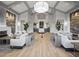 Spacious lounge area with stylish sofas, decorative accents, warm lighting, and an inviting atmosphere at 16904 Vardon Ter # 201, Bradenton, FL 34211
