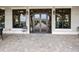 Covered patio entry leading to an outdoor path with a view of nearby landscaping and buildings at 16904 Vardon Ter # 201, Bradenton, FL 34211