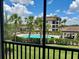 Screened patio view of a sparkling community pool and well-manicured landscaping at 16904 Vardon Ter # 201, Bradenton, FL 34211