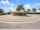 Beautiful roundabout with palm trees and landscaping adding a tropical feel to the community entrance at 16904 Vardon Ter # 201, Bradenton, FL 34211
