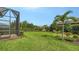Expansive green backyard with well-maintained lawn, privacy landscaping, and screened lanai views at 17905 Waterville Pl, Bradenton, FL 34202