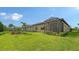 Spacious backyard featuring lush green lawn, mature landscaping, and screened-in lanai at 17905 Waterville Pl, Bradenton, FL 34202