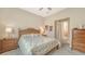 Bedroom featuring floral bedding, ceiling fan, and two wood nightstands at 17905 Waterville Pl, Bradenton, FL 34202