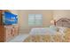 Relaxing bedroom features a floral patterned bed, TV, and plantation shutters at 17905 Waterville Pl, Bradenton, FL 34202