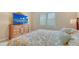 Bedroom features decorative bedding, flatscreen TV and plantation shutters at 17905 Waterville Pl, Bradenton, FL 34202