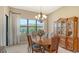 Formal dining room with a large table, ornate hutch, and window view at 17905 Waterville Pl, Bradenton, FL 34202