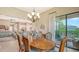 Dining room with slider access to the patio, view of the kitchen, and a large dining table at 17905 Waterville Pl, Bradenton, FL 34202