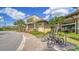 Exterior view of a building with a bike rack and lush landscaping in front at 17905 Waterville Pl, Bradenton, FL 34202