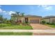 Beautiful single-story home featuring a lush landscaped yard, paver driveway, and well-maintained exterior at 17905 Waterville Pl, Bradenton, FL 34202