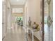 Inviting hallway with tiled floors and an ornamental table at 17905 Waterville Pl, Bradenton, FL 34202