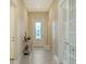 Bright hallway features a decorative glass front door and stylish tile flooring at 17905 Waterville Pl, Bradenton, FL 34202
