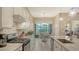 Bright kitchen with white cabinets, stainless steel appliances, and a view of the dining area and backyard at 17905 Waterville Pl, Bradenton, FL 34202