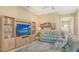 Cozy living room with a large TV on a wooden cabinet and comfortable leather sofas at 17905 Waterville Pl, Bradenton, FL 34202
