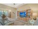 Elegant living room featuring a large TV, wooden cabinet, and comfortable leather sofas at 17905 Waterville Pl, Bradenton, FL 34202