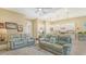 Open concept living area with couches and kitchen featuring stainless steel appliances, and granite countertops at 17905 Waterville Pl, Bradenton, FL 34202