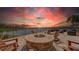 Beautiful outdoor patio with a fire pit, comfortable seating, and scenic lake views at 17905 Waterville Pl, Bradenton, FL 34202