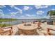 Beautiful outdoor patio with a fire pit, comfortable seating, and scenic lake views at 17905 Waterville Pl, Bradenton, FL 34202