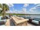 Outdoor patio with lake views, seating, and stone fire table perfect for relaxing at 17905 Waterville Pl, Bradenton, FL 34202