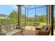 Screened lanai features comfortable seating and views of the lush backyard landscaping at 17905 Waterville Pl, Bradenton, FL 34202