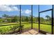A screened-in porch with brick flooring offers beautiful views of the landscaped backyard at 17905 Waterville Pl, Bradenton, FL 34202