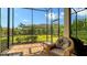 A screened-in porch with brick flooring offers beautiful views of the landscaped backyard at 17905 Waterville Pl, Bradenton, FL 34202