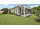 A well-manicured lawn and landscaping provide a tranquil backdrop for the enclosed patio space at 1831 San Silvestro Dr, Venice, FL 34285