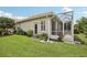 Lush backyard with a cozy, screened-in patio, perfect for enjoying the outdoors comfortably and bug-free at 1831 San Silvestro Dr, Venice, FL 34285