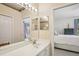Elegant bathroom mirror reflects the bedroom, showcasing an ensuite design with stylish fixtures and decor at 1831 San Silvestro Dr, Venice, FL 34285