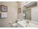 Inviting bathroom featuring a tiled shower, white toilet, and vanity with a well-lit mirror for a fresh feel at 1831 San Silvestro Dr, Venice, FL 34285