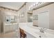 Bright bathroom featuring a white vanity with a marble countertop and a large mirror, perfect for getting ready at 1831 San Silvestro Dr, Venice, FL 34285