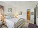 Comfortable bedroom with a white bed frame, side tables, and access to an ensuite bathroom for convenience at 1831 San Silvestro Dr, Venice, FL 34285